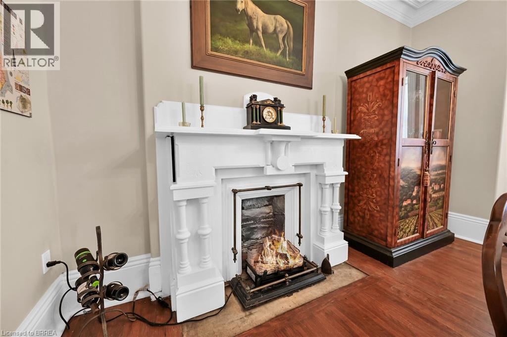 Room details with crown molding and hardwood / wood-style floors - 40 Locke Street S, Hamilton, ON - Indoor With Fireplace