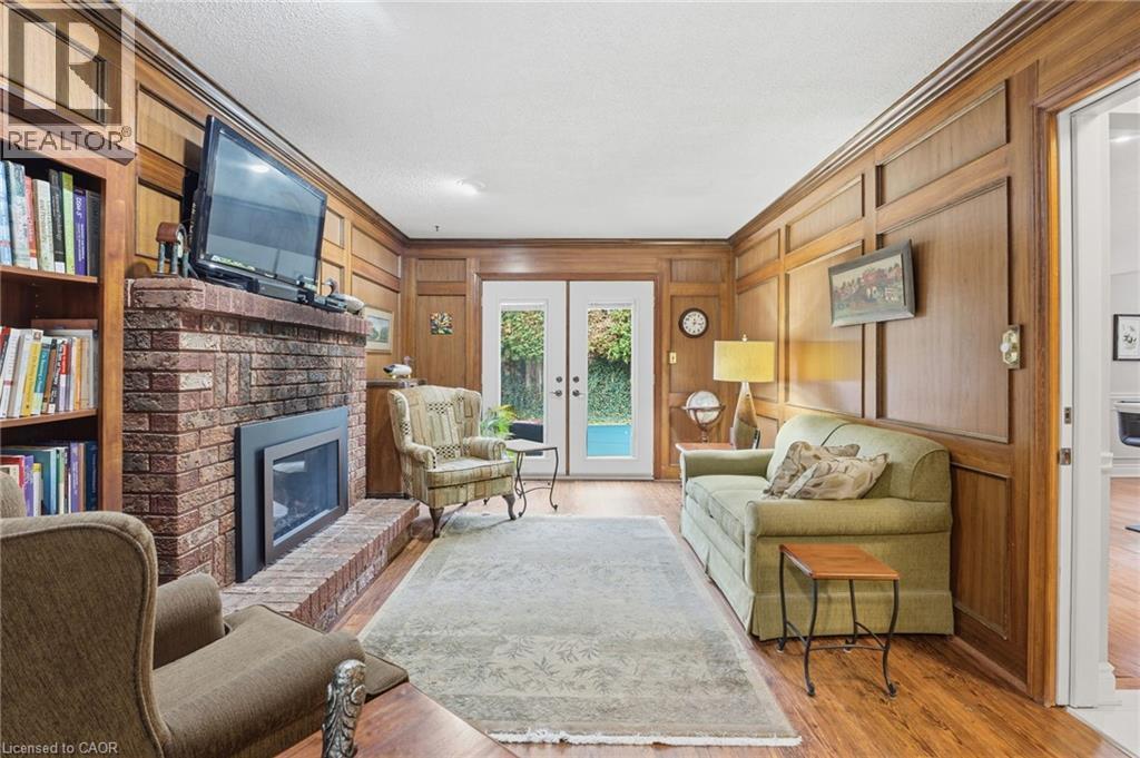 ""Fireside"" room with french doors to patio - 668 Tomahawk Crescent, Ancaster, ON - Indoor Photo Showing Living Room With Fireplace