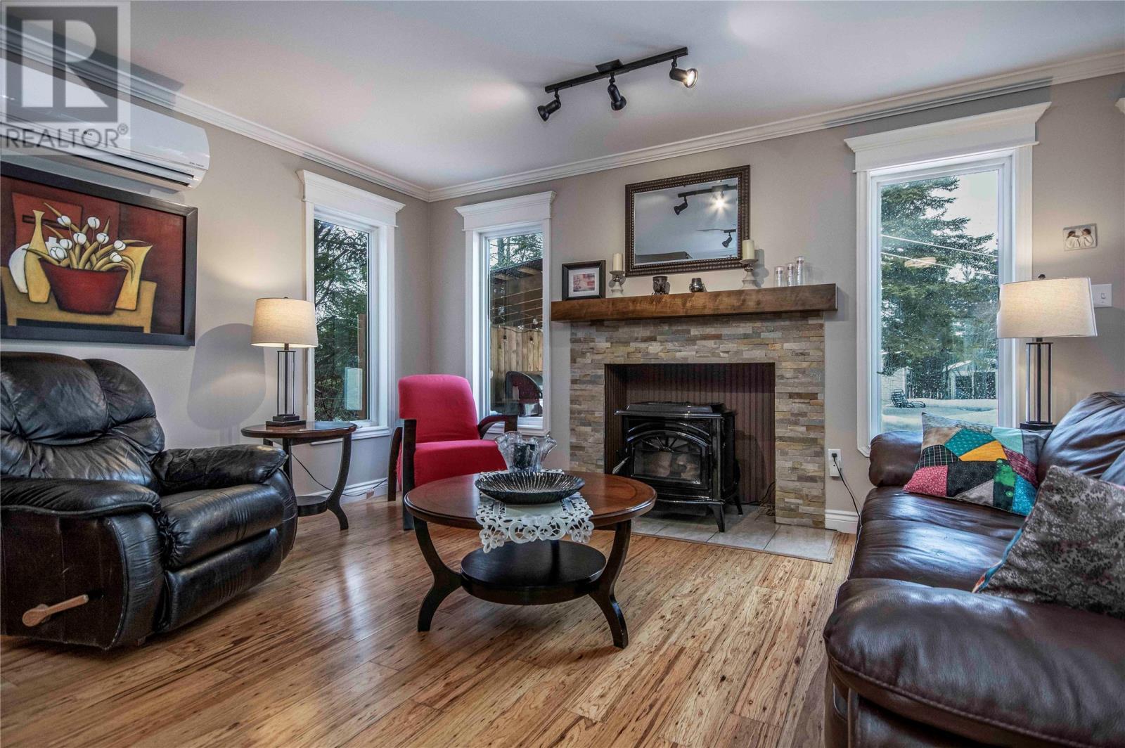 Living room with pellet stove and mini split - 34 Blackstrap Path, Conception Bay South, NL - Indoor Photo Showing Living Room With Fireplace