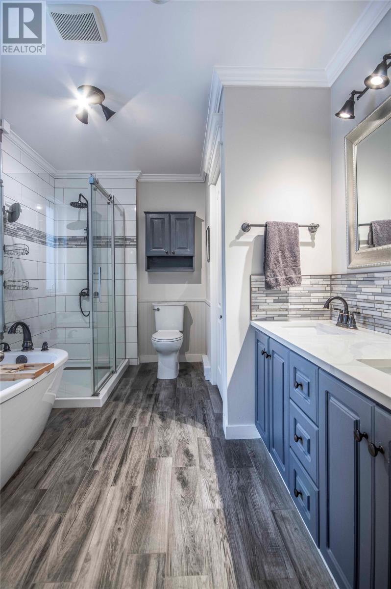 Ensuite with heated floors, shower, soaker tub w/ walk in closet - 34 Blackstrap Path, Conception Bay South, NL - Indoor Photo Showing Bathroom