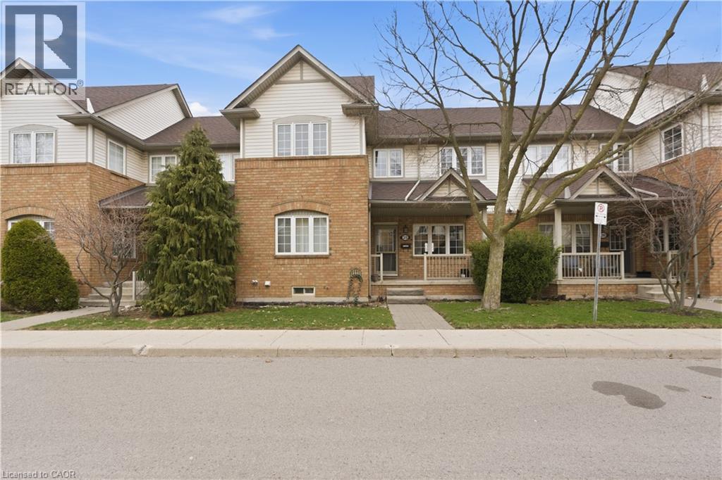 Traditional-style home featuring covered porch and brick siding - 100 Beddoe Drive Unit# 25, Hamilton, ON - Outdoor With Facade