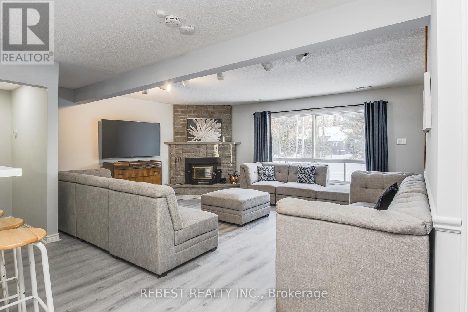 910 Concession Rd 17 W, Tiny, ON - Indoor Photo Showing Living Room With Fireplace