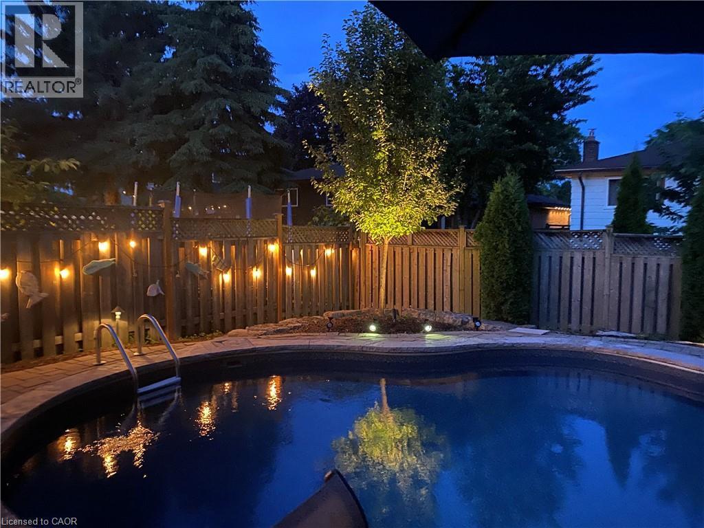 Pool at twilight with a fenced backyard - 3354 Bristol Drive, Burlington, ON - Outdoor With In Ground Pool