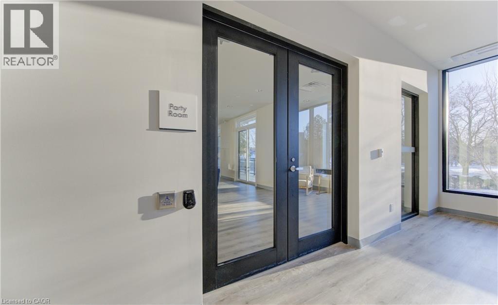 Entryway featuring wood finished floors and french doors - 103 Roger Street Unit# 310, Waterloo, ON - Indoor Photo Showing Other Room