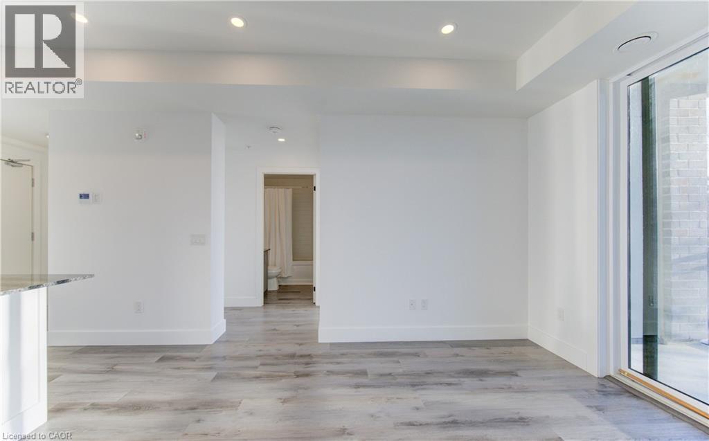 Unfurnished room with light wood finished floors and recessed lighting - 103 Roger Street Unit# 310, Waterloo, ON - Indoor Photo Showing Other Room