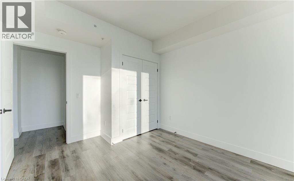 Unfurnished bedroom with light wood-type flooring and a closet - 103 Roger Street Unit# 310, Waterloo, ON - Indoor Photo Showing Other Room