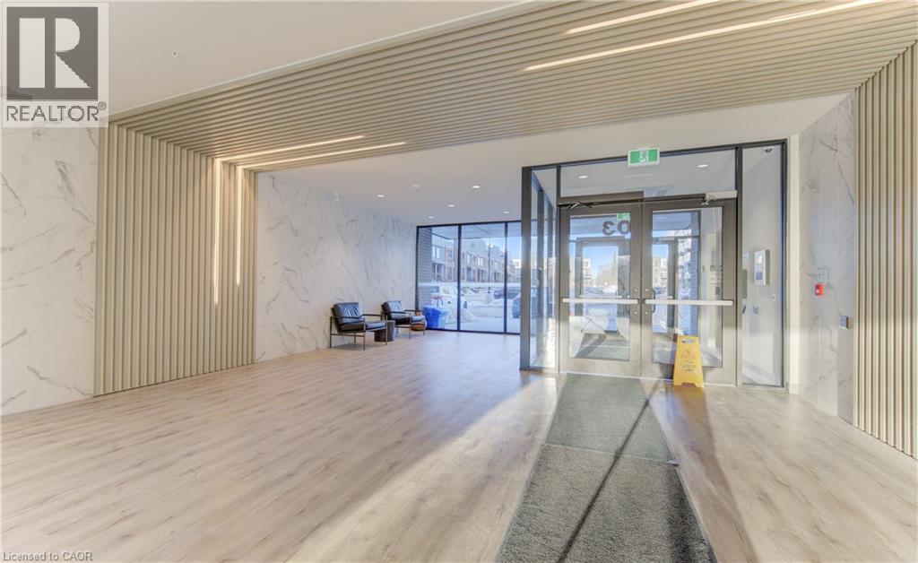 Common area featuring expansive windows - 103 Roger Street Unit# 310, Waterloo, ON - Indoor Photo Showing Other Room