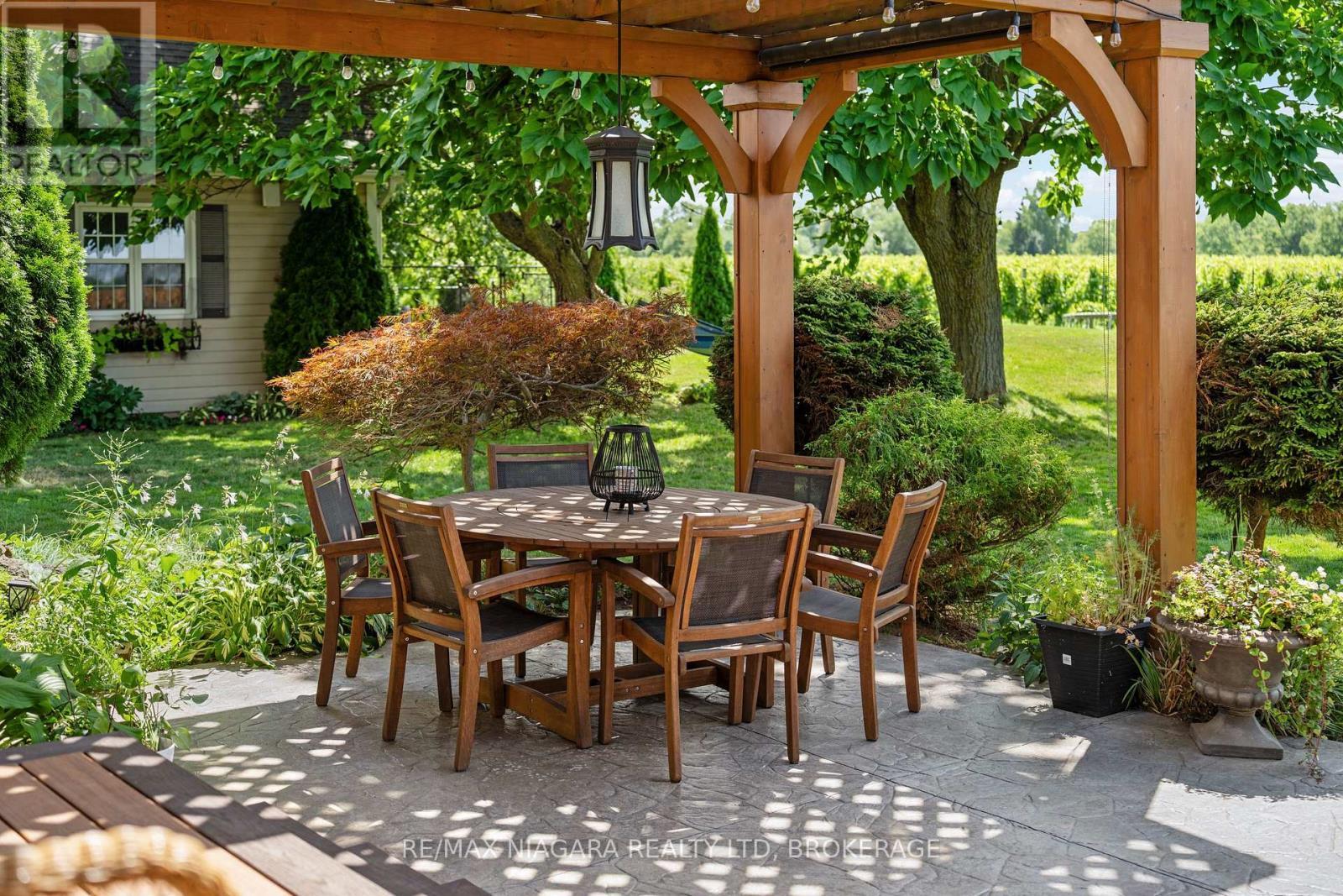 Small fishpond with waterfall beside patio area - 2231 Seventh Street, St. Catharines (Rural Fourth), ON - Outdoor With Deck Patio Veranda