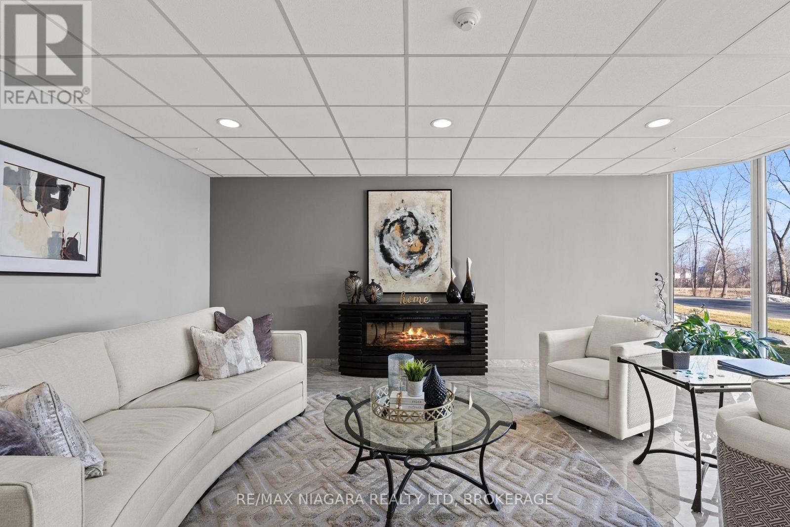 601 - 81 Scott Street, St. Catharines (Lakeport), ON - Indoor Photo Showing Living Room With Fireplace