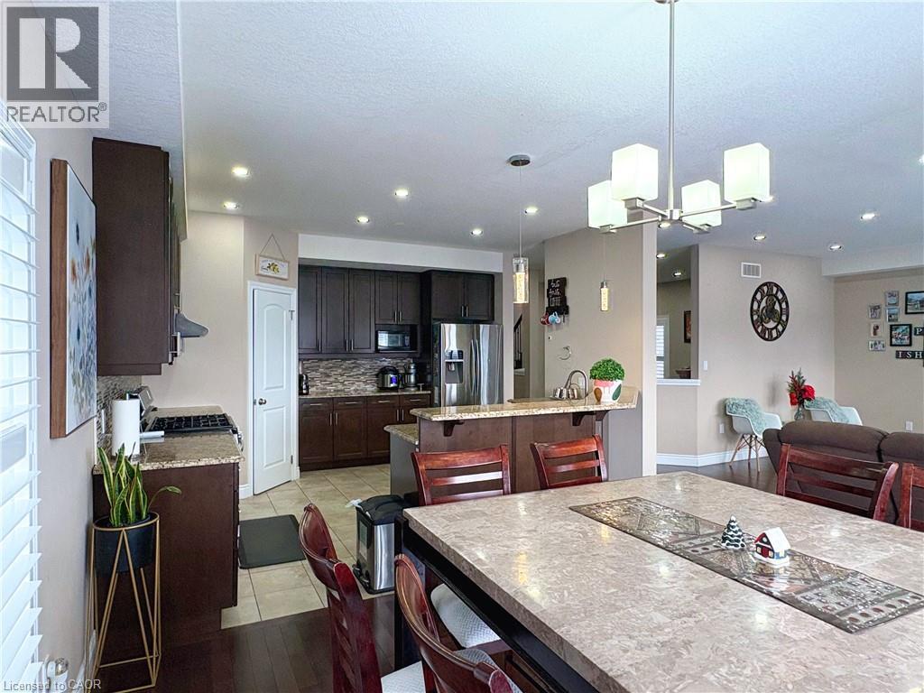 Dining room featuring light tile patterned floors, a textured ceiling, and a chandelier - 34 Watervale Drive Unit# Upper, Kitchener, ON - Indoor