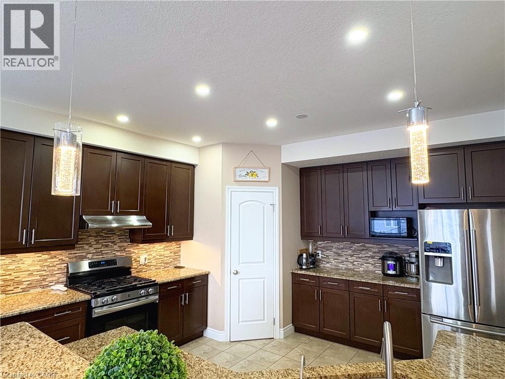 Kitchen with appliances with stainless steel finishes, pendant lighting, and decorative backsplash - 34 Watervale Drive Unit# Upper, Kitchener, ON - Indoor Photo Showing Kitchen With Upgraded Kitchen