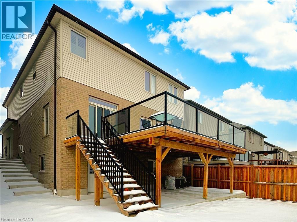 View of snow covered rear of property - 34 Watervale Drive Unit# Upper, Kitchener, ON - Outdoor With Deck Patio Veranda