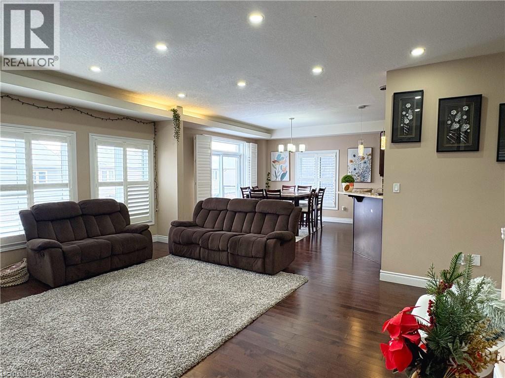 Living room with dark wood-type flooring and a textured ceiling - 34 Watervale Drive Unit# Upper, Kitchener, ON - Indoor Photo Showing Living Room