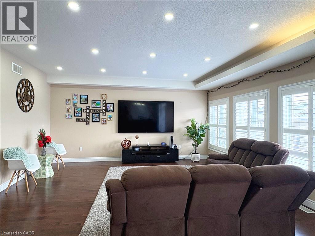 Living room featuring dark wood-type flooring and a textured ceiling - 34 Watervale Drive Unit# Upper, Kitchener, ON - Indoor Photo Showing Living Room