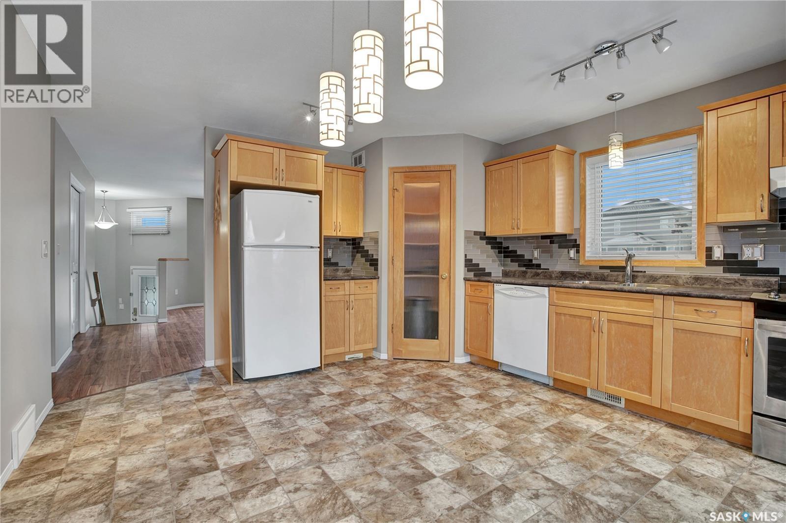 1131 Denham Rise, Saskatoon, SK - Indoor Photo Showing Kitchen With Double Sink