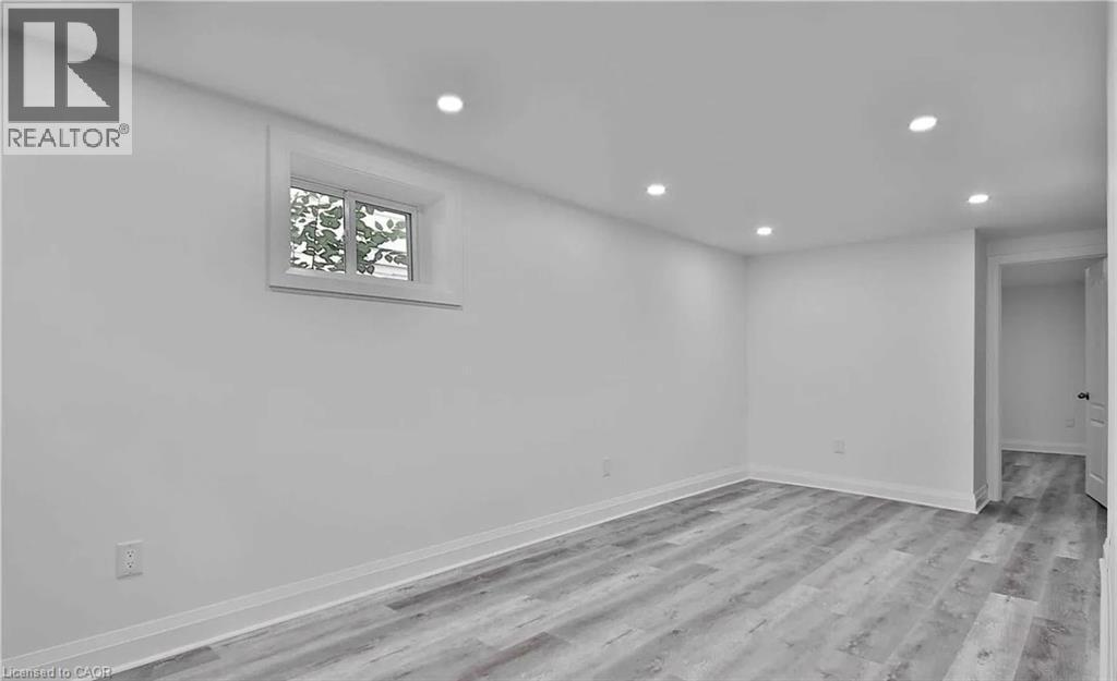 Living room with light wood finished floors and recessed lighting - 549 Waterloo Street, Hamilton, ON - Indoor Photo Showing Other Room