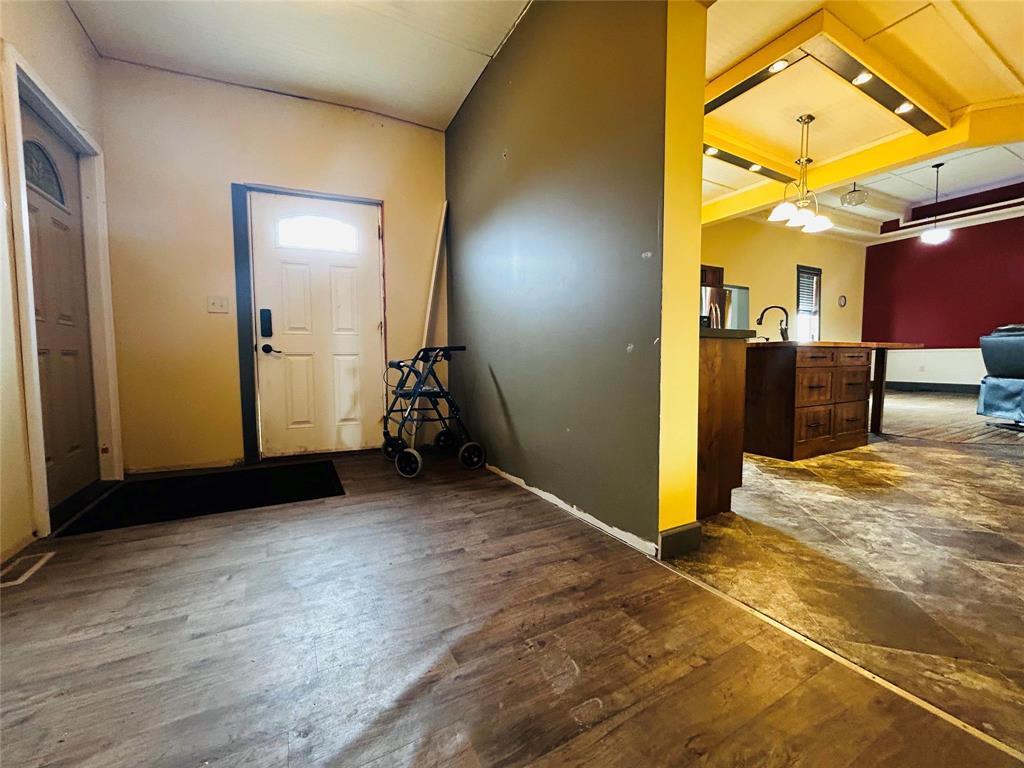 Mudroom/breezeway with entry to front and back of home as well as the attached garage. - Pierson, Manitoba