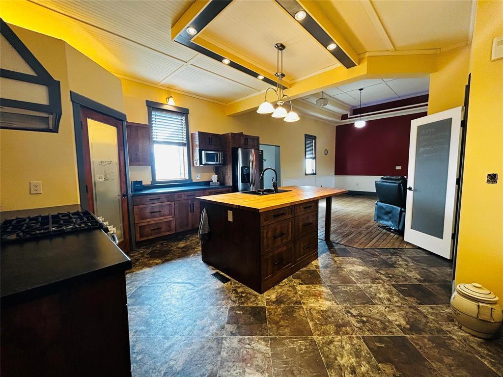 A spacious kitchen open concept to the main living area and adjacent to the 2 pc. bath/laundry room /mud room/utility room with access to the attached garage. - Pierson, Manitoba