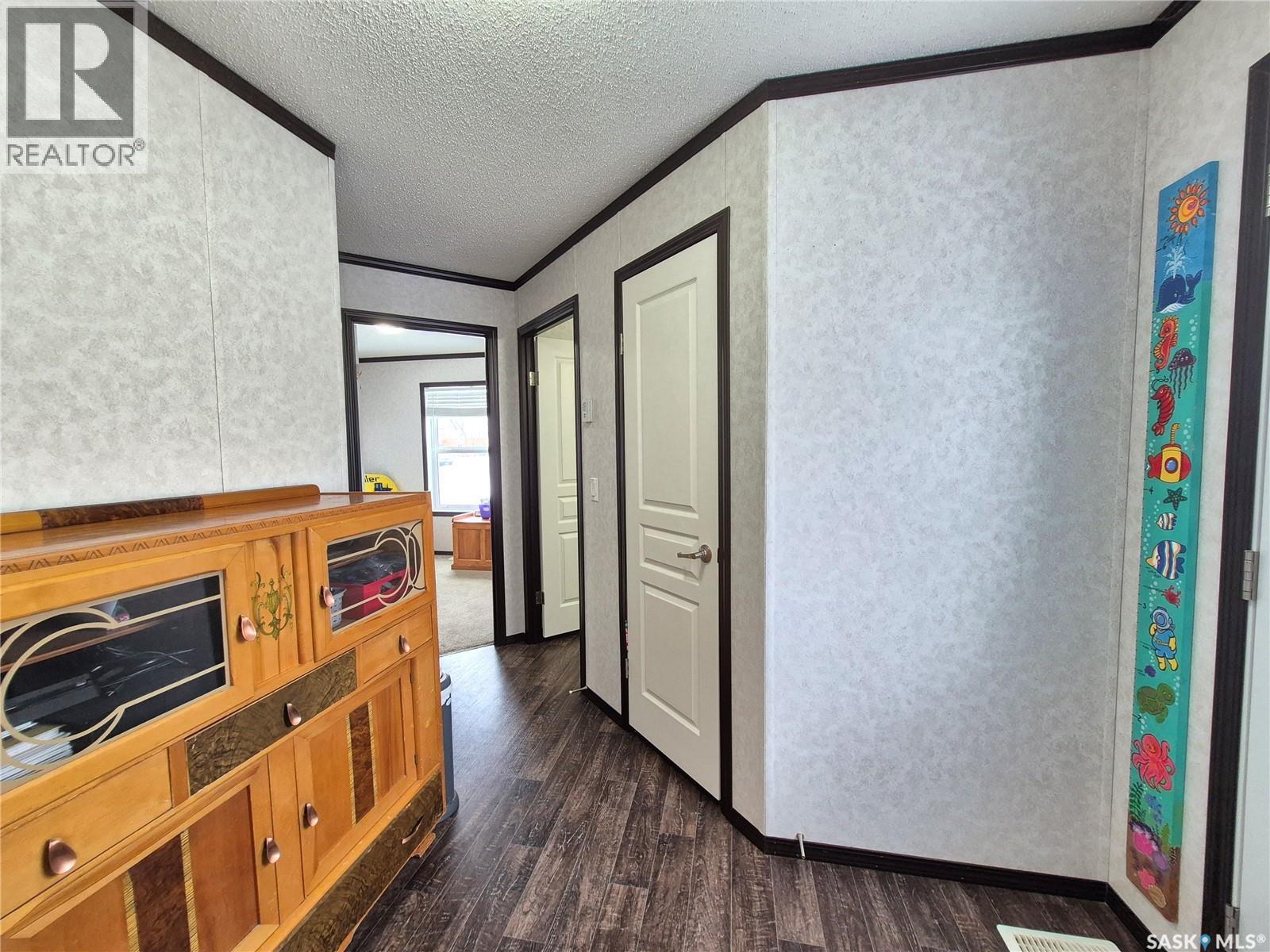 151 2Nd Avenue, Bengough, SK - Indoor Photo Showing Other Room With Fireplace