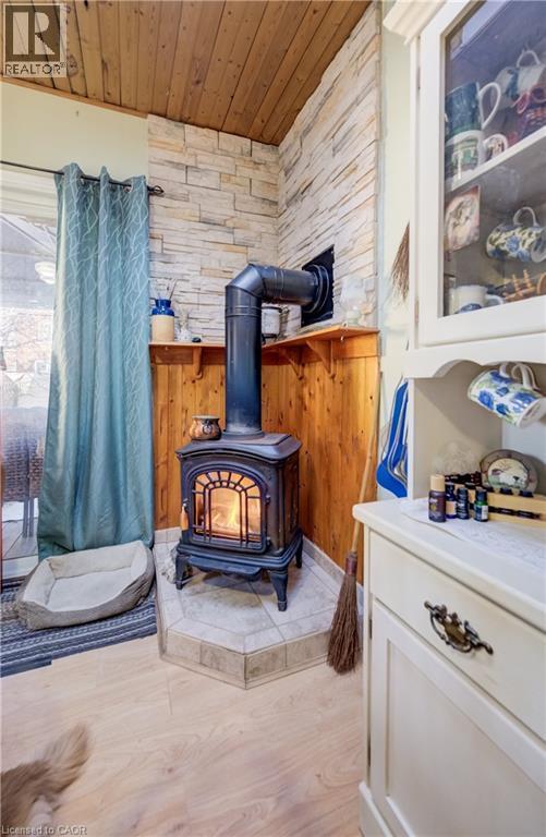 cozy gas fireplace in huge kitchen - 12 Leinster Avenue S, Hamilton, ON - Indoor Photo Showing Other Room With Fireplace
