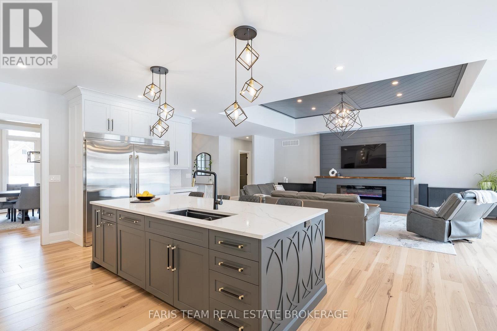 7 Reynolds Road, Tiny, ON - Indoor Photo Showing Kitchen With Fireplace With Double Sink With Upgraded Kitchen