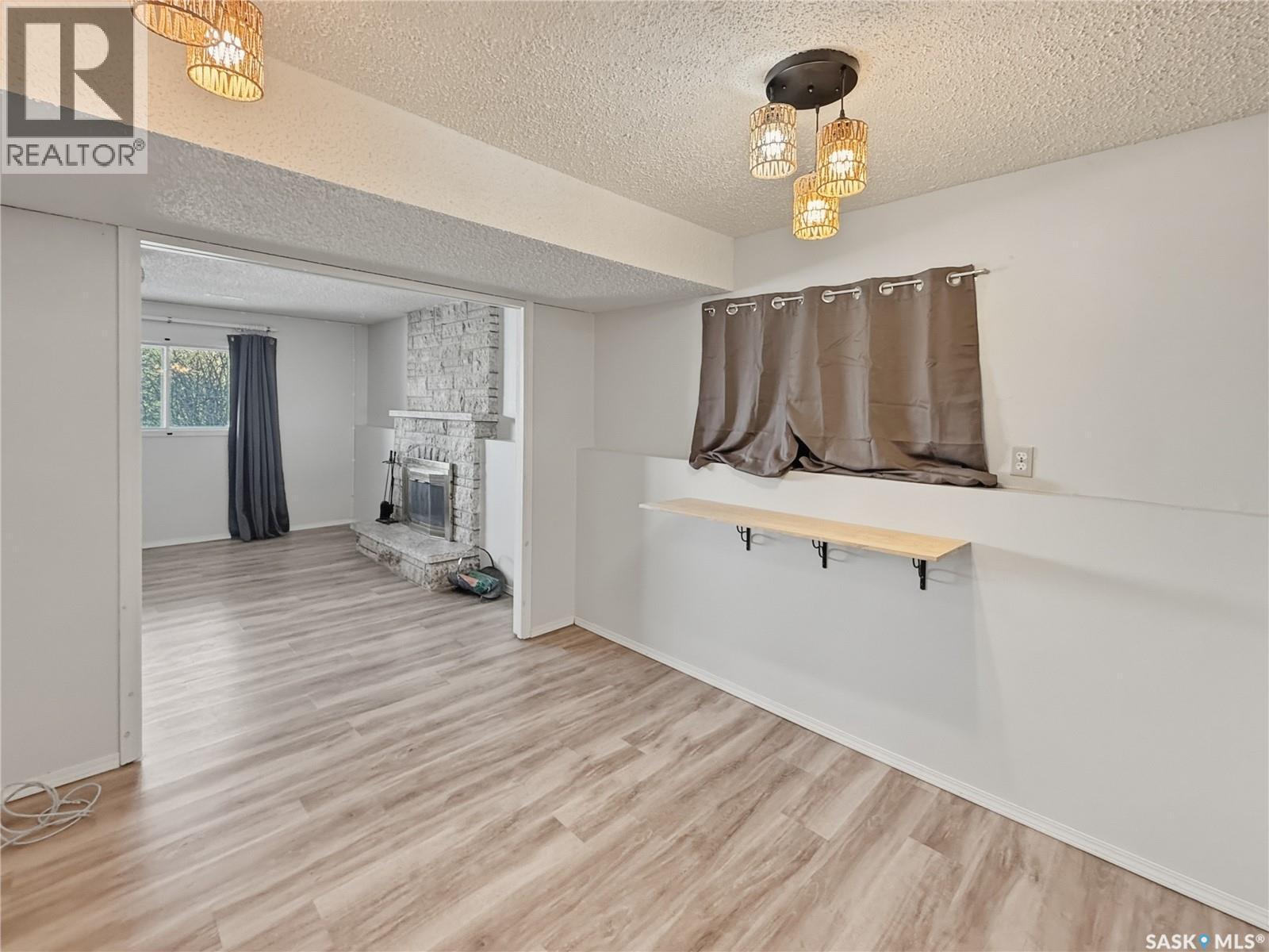 264 Hayes Drive, Swift Current, SK - Indoor Photo Showing Other Room With Fireplace