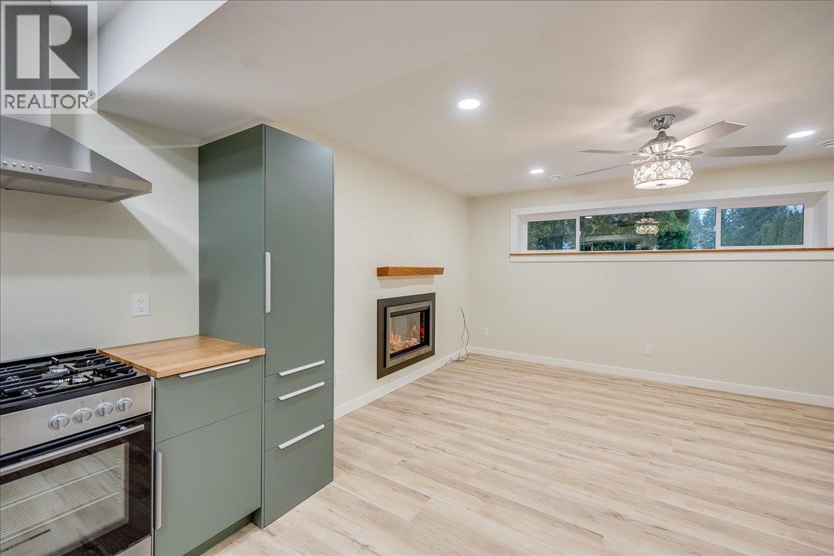 1408 Meadowbrook Drive, Castlegar, BC - Indoor Photo Showing Kitchen With Fireplace