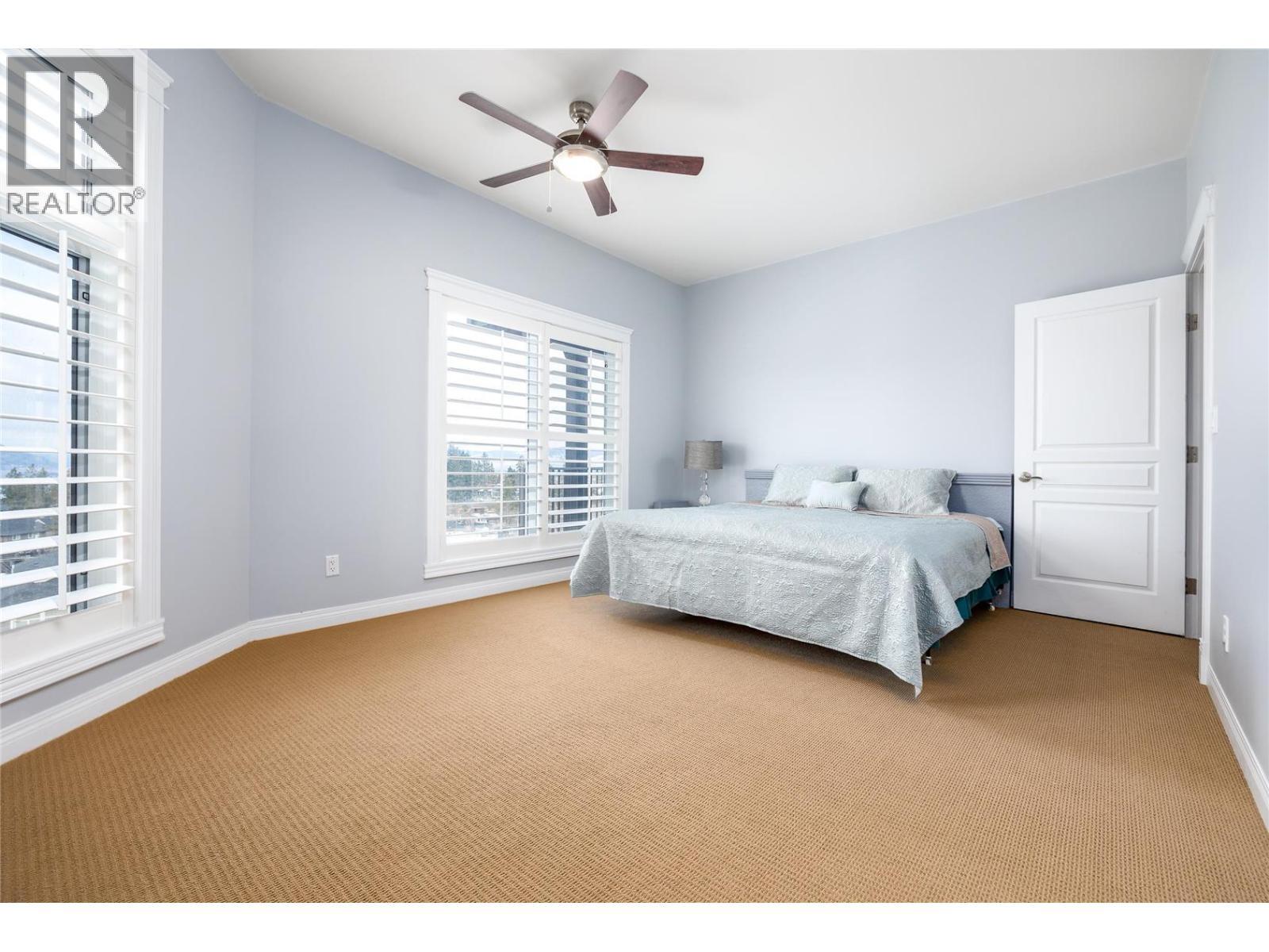 Another bedroom with view - 375 Trumpeter Court, Kelowna, BC - Indoor Photo Showing Bedroom