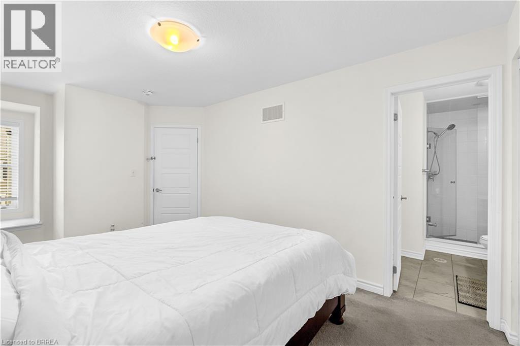 Carpeted bedroom with baseboards and tile patterned flooring - 143 Ridge Road Unit# 48, Cambridge, ON - Indoor Photo Showing Bedroom