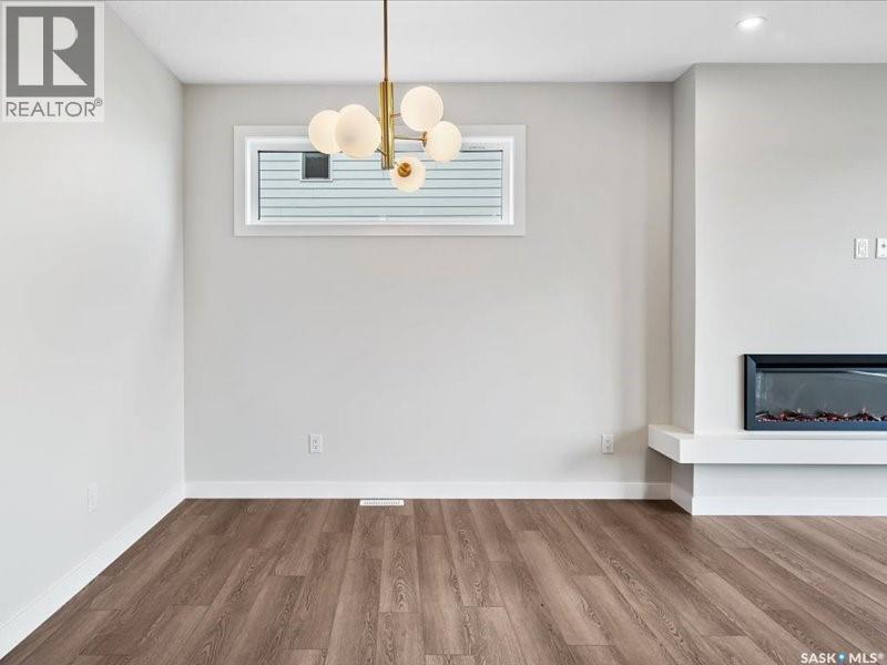 107 Katz Avenue, Saskatoon, SK - Indoor Photo Showing Other Room With Fireplace