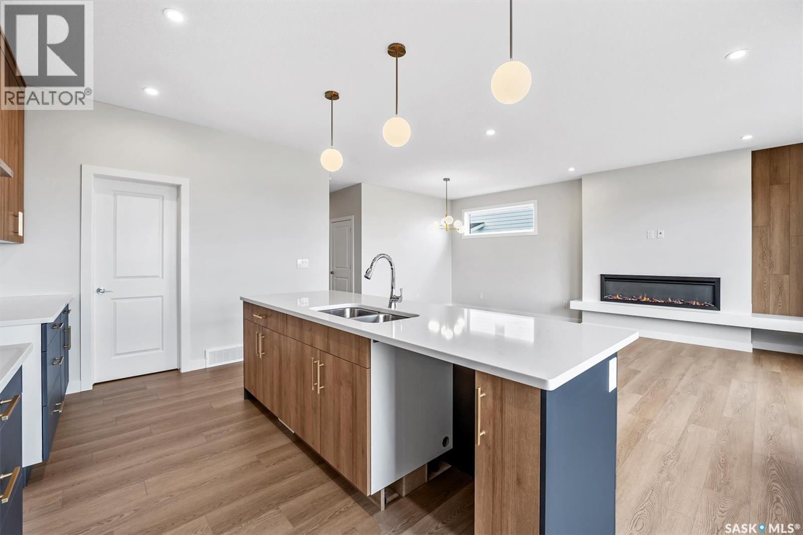 107 Katz Avenue, Saskatoon, SK - Indoor Photo Showing Kitchen With Fireplace With Double Sink With Upgraded Kitchen