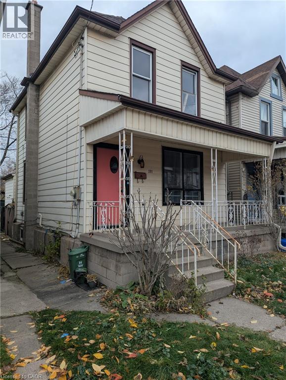 View of front of property featuring a chimney and a porch - 151 Gibson Avenue, Hamilton, ON - Outdoor With Deck Patio Veranda