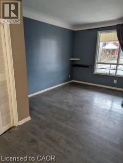 Empty room featuring baseboards and dark wood finished floors - 151 Gibson Avenue, Hamilton, ON - Indoor Photo Showing Other Room