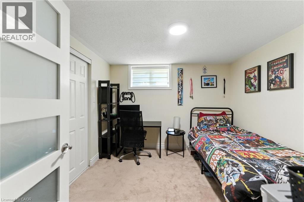 Bedroom with a textured ceiling, light colored carpet and a closet - 90 Toby Crescent Unit# Lower, Hamilton, ON - Indoor Photo Showing Bedroom