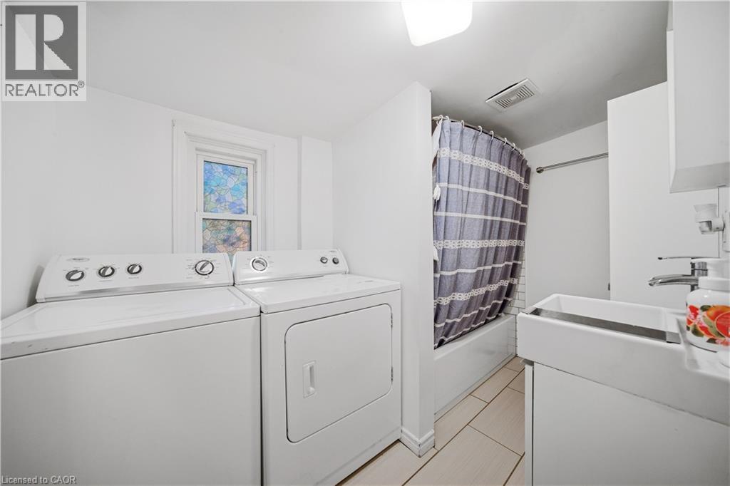 2nd Floor Bathroom. Washer/Dryer Also Located in Bathroom, Subway Tile Back-splash - 107 Queen Street S, Hamilton, ON - Indoor Photo Showing Laundry Room