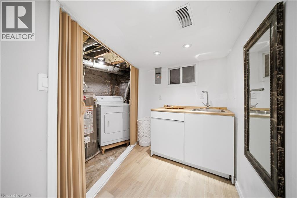 Basement laundry and sink - 107 Queen Street S, Hamilton, ON - Indoor Photo Showing Laundry Room