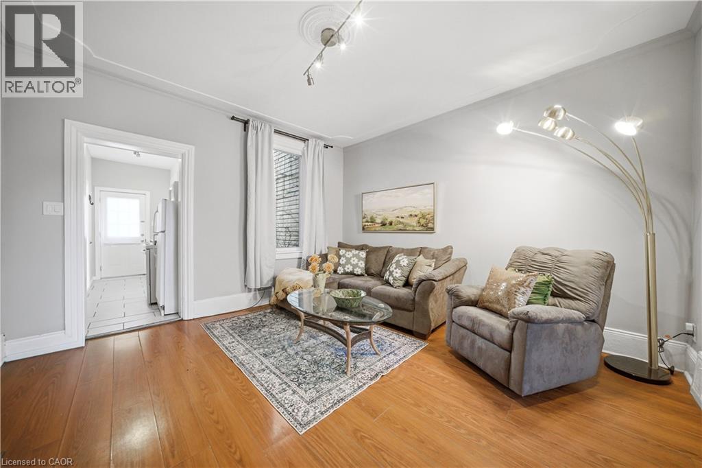 Main floor Living Room. Spacious and Bright, Laminate Flooring, 9 ft Ceilings! - 107 Queen Street S, Hamilton, ON - Indoor Photo Showing Living Room