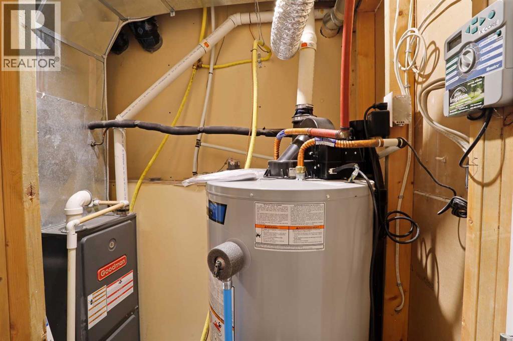 Basement Furnace Utilty Room beside laundry room - 322 17 Street E, Brooks, AB - Indoor Photo Showing Basement