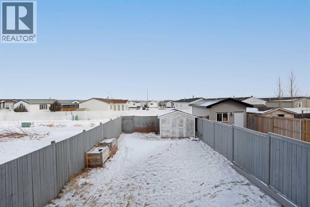 Fenced Backyard w/small shed - 322 17 Street E, Brooks, AB - Outdoor