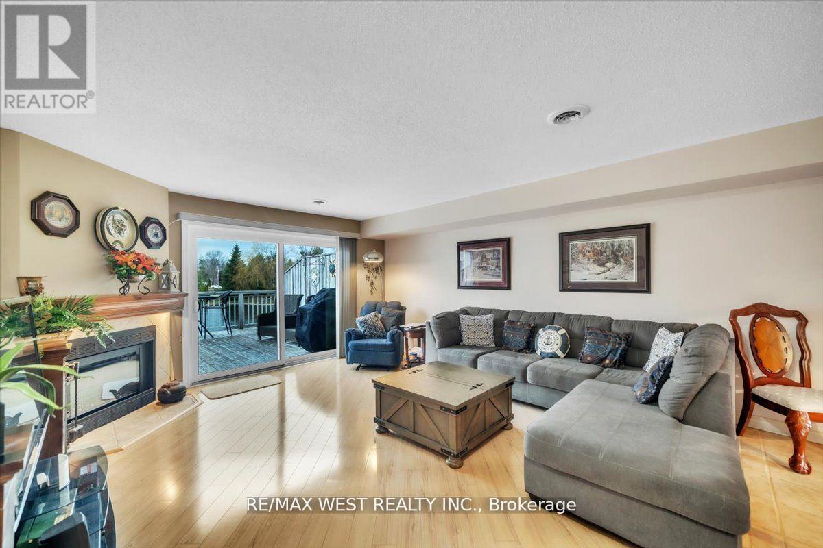 9 - 24 Laguna Parkway, Ramara, ON - Indoor Photo Showing Living Room With Fireplace