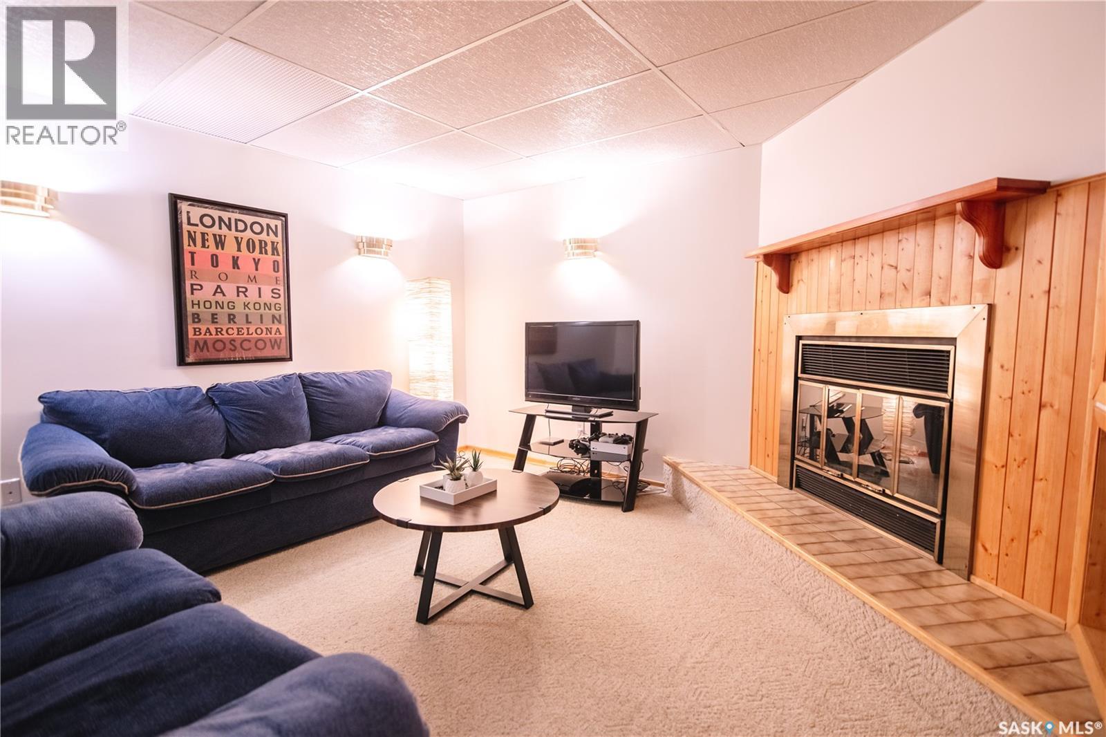 1222 Flexman Crescent N, Regina, SK - Indoor Photo Showing Living Room With Fireplace