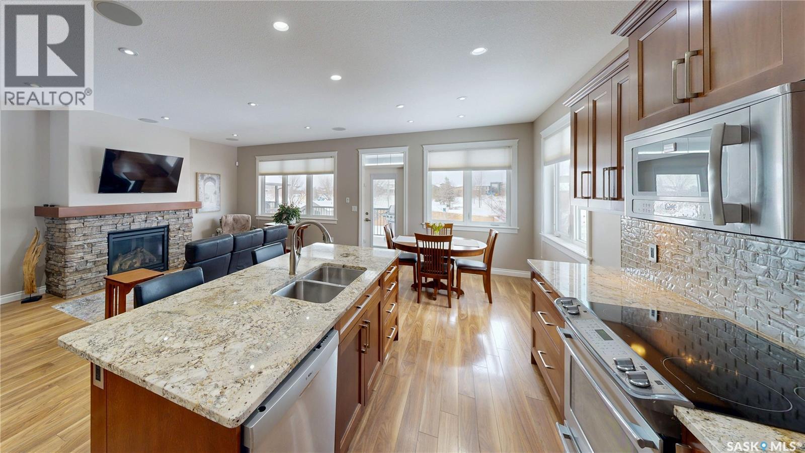 4342 Skinner Place, Regina, SK - Indoor Photo Showing Kitchen With Fireplace With Double Sink With Upgraded Kitchen
