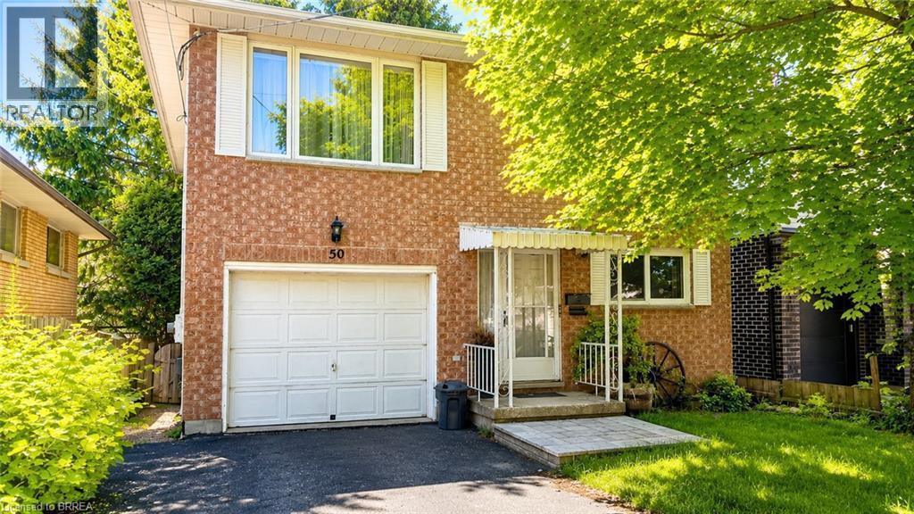 Brick exterior with white window shutters and a front entrance awning - 50 South Drive, Kitchener, ON