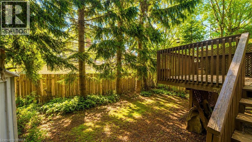 Elevated wood deck with baluster railing and steps - 50 South Drive, Kitchener, ON