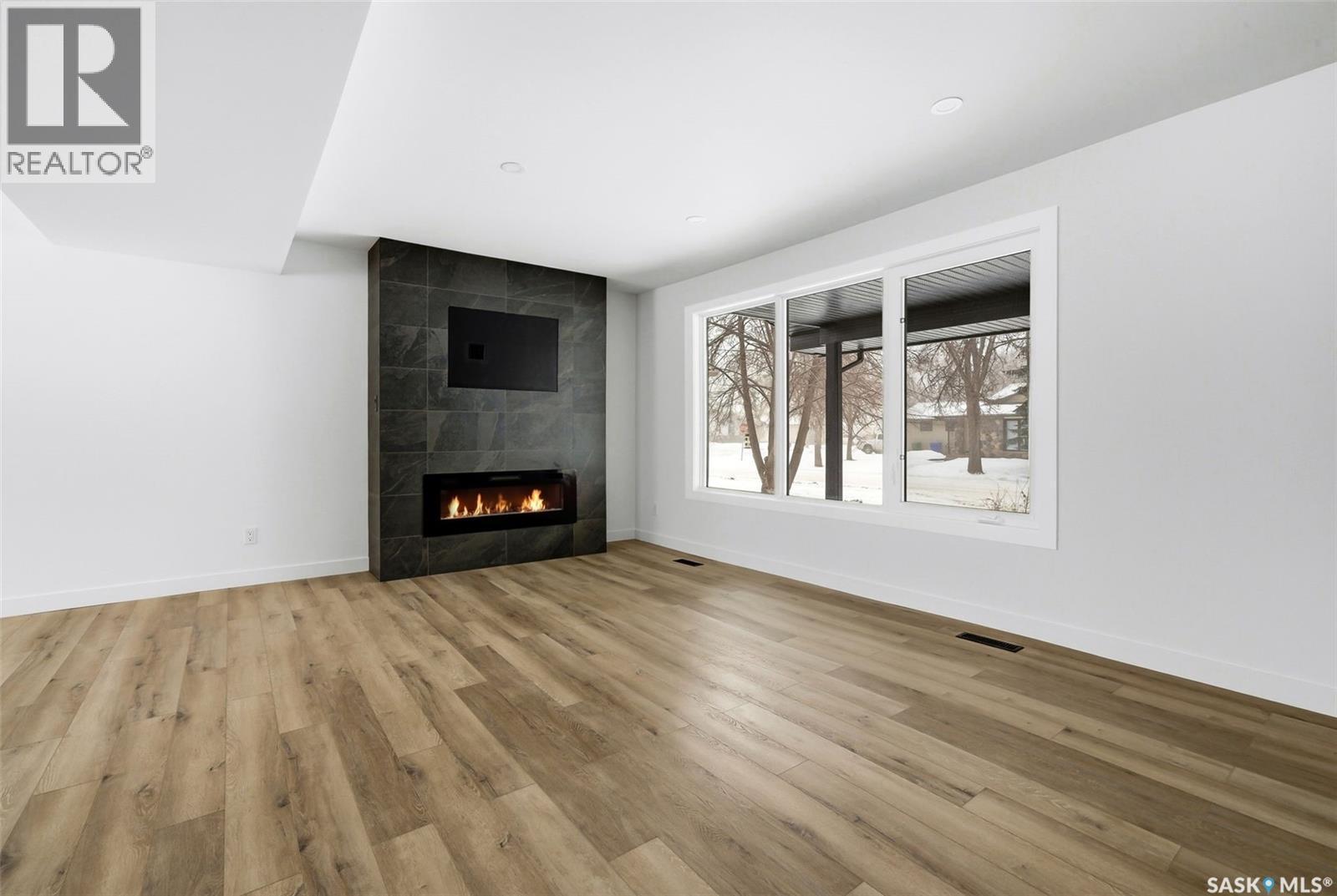 8 Thatcher Road, Regina, SK - Indoor Photo Showing Living Room With Fireplace