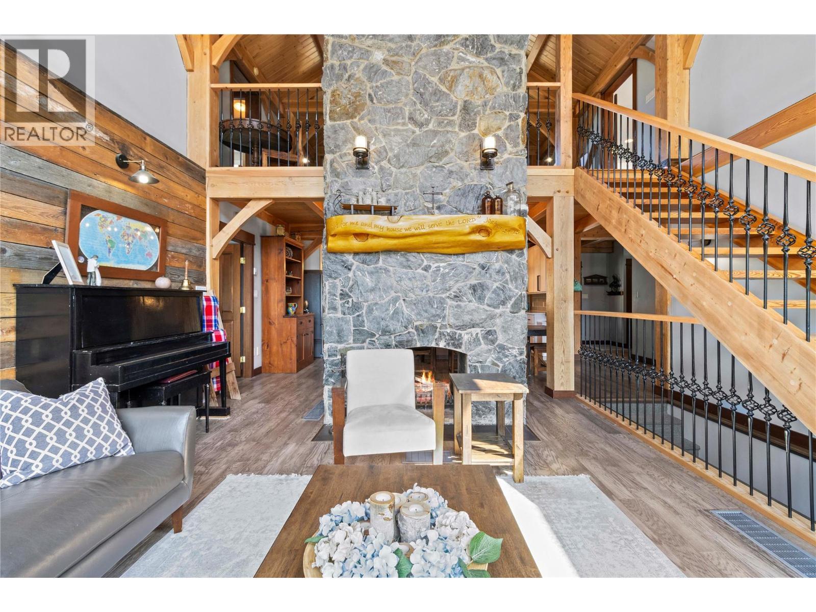 Massive fieldstone fireplace - 1403 Notch Hill Road, Sorrento, BC - Photo Showing Other Room