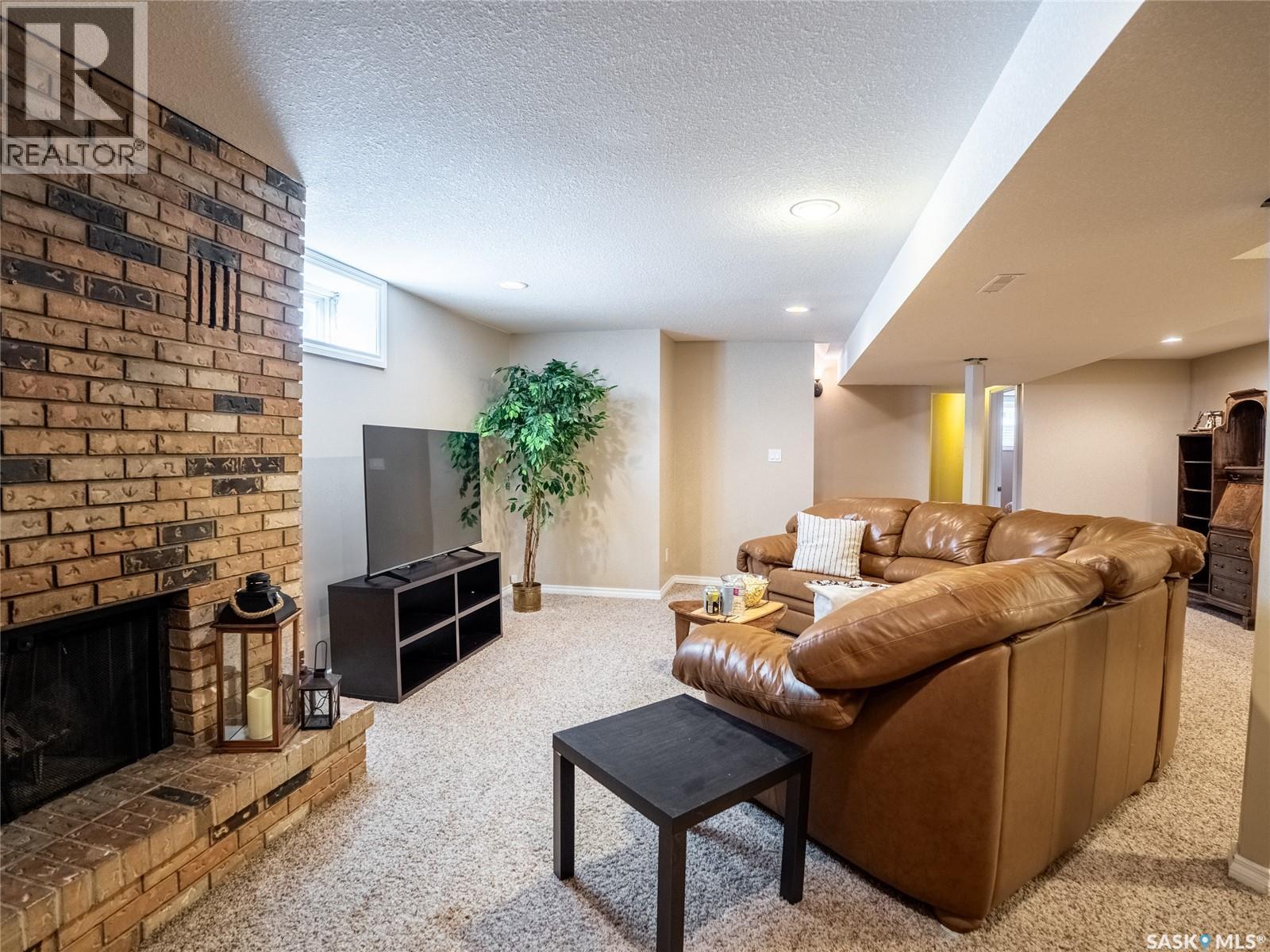 128 Mcdougall Crescent, Regina, SK - Indoor Photo Showing Living Room With Fireplace