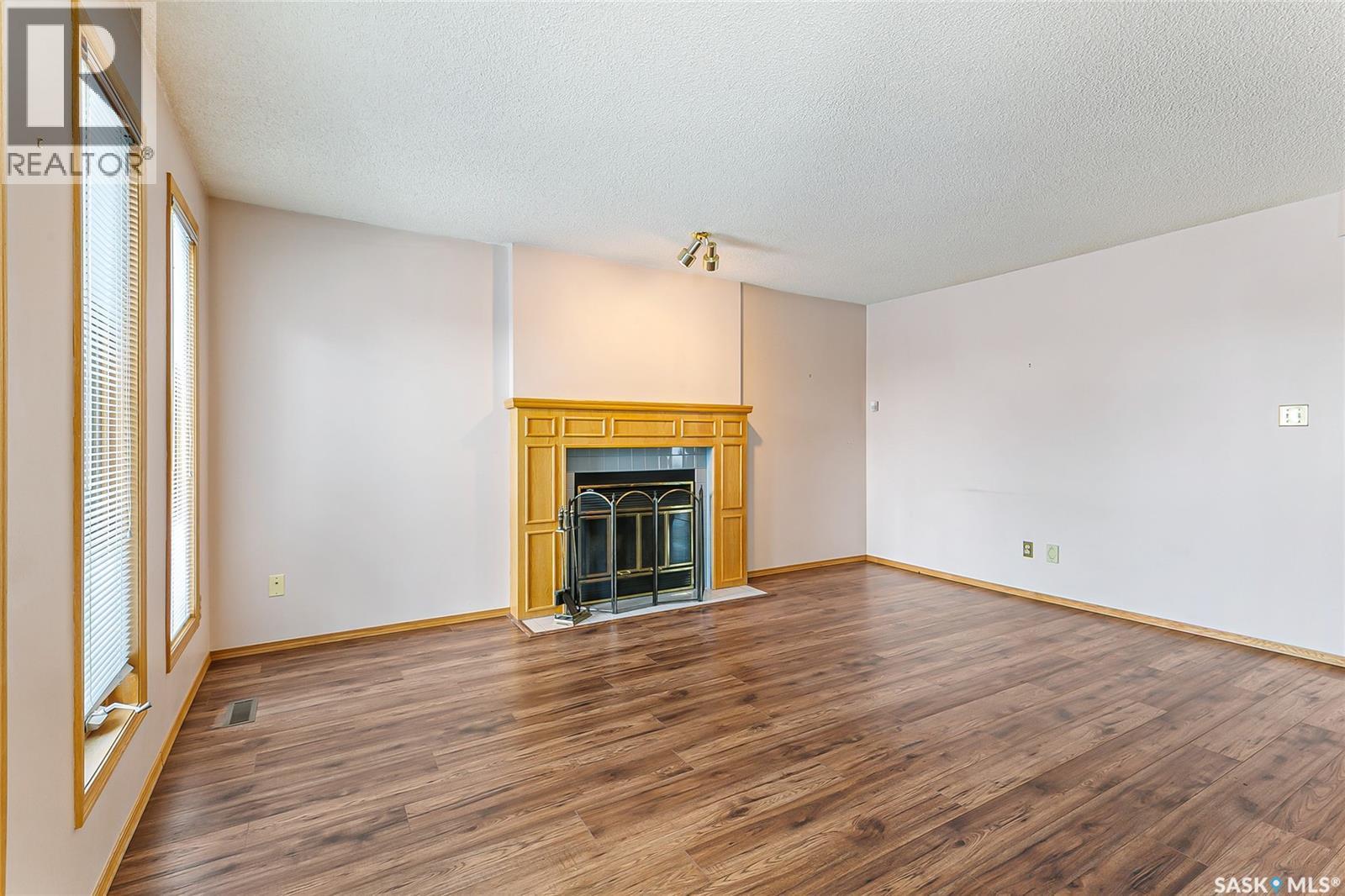 1328 Benjamin Crescent N, Regina, SK - Indoor Photo Showing Living Room With Fireplace