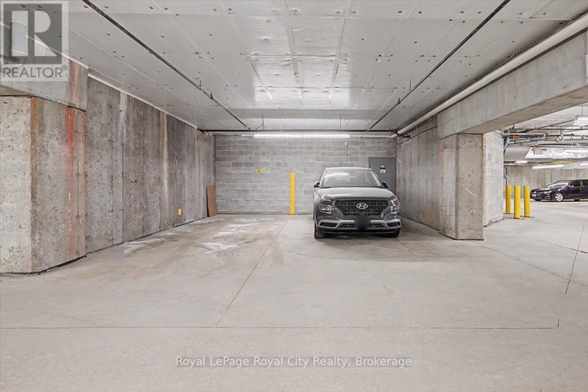 Parking space with locker room behind - 412 - 308 Watson Parkway N, Guelph (Grange Road), ON - Indoor Photo Showing Garage