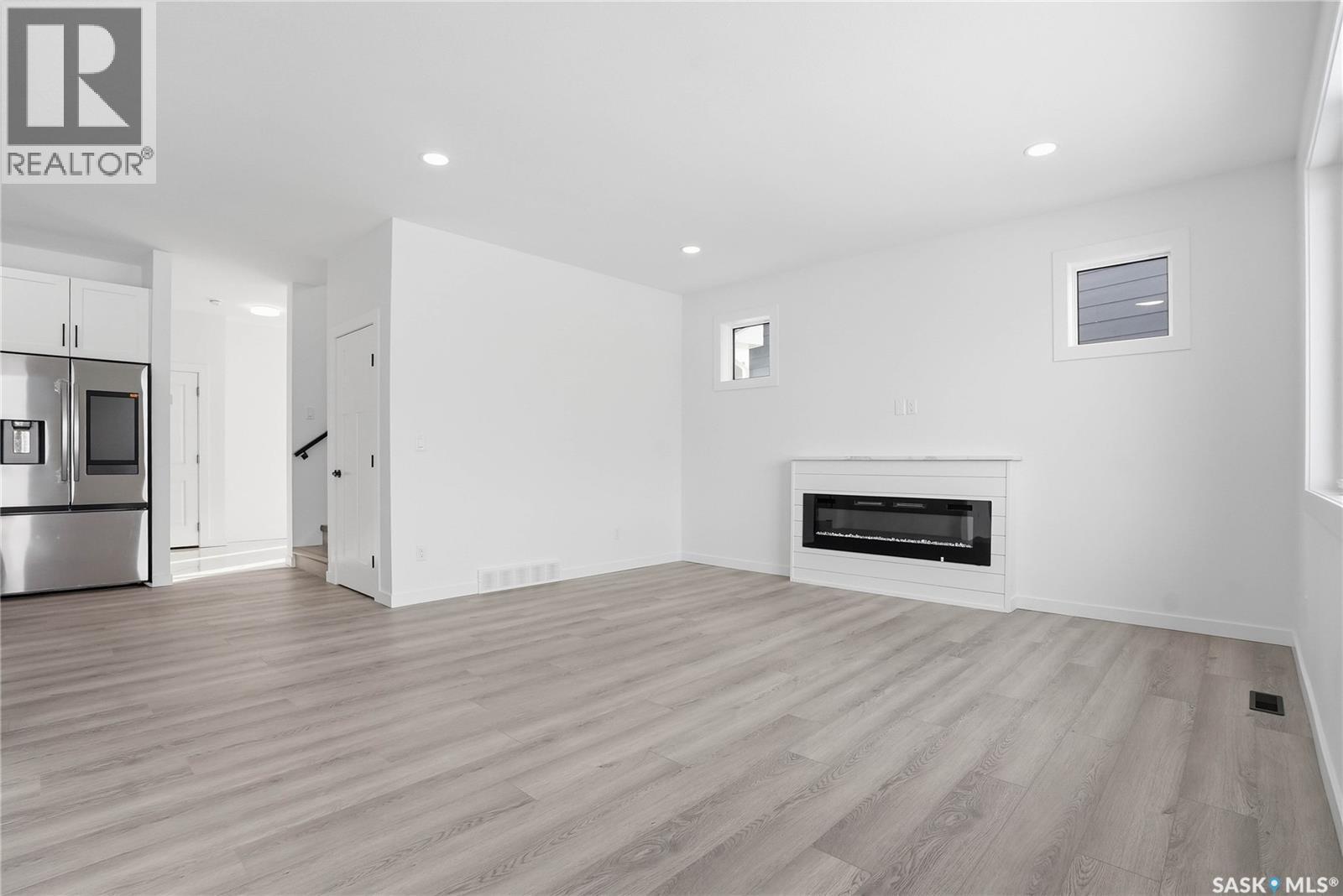 139 Sharma Lane, Saskatoon, SK - Indoor Photo Showing Living Room With Fireplace